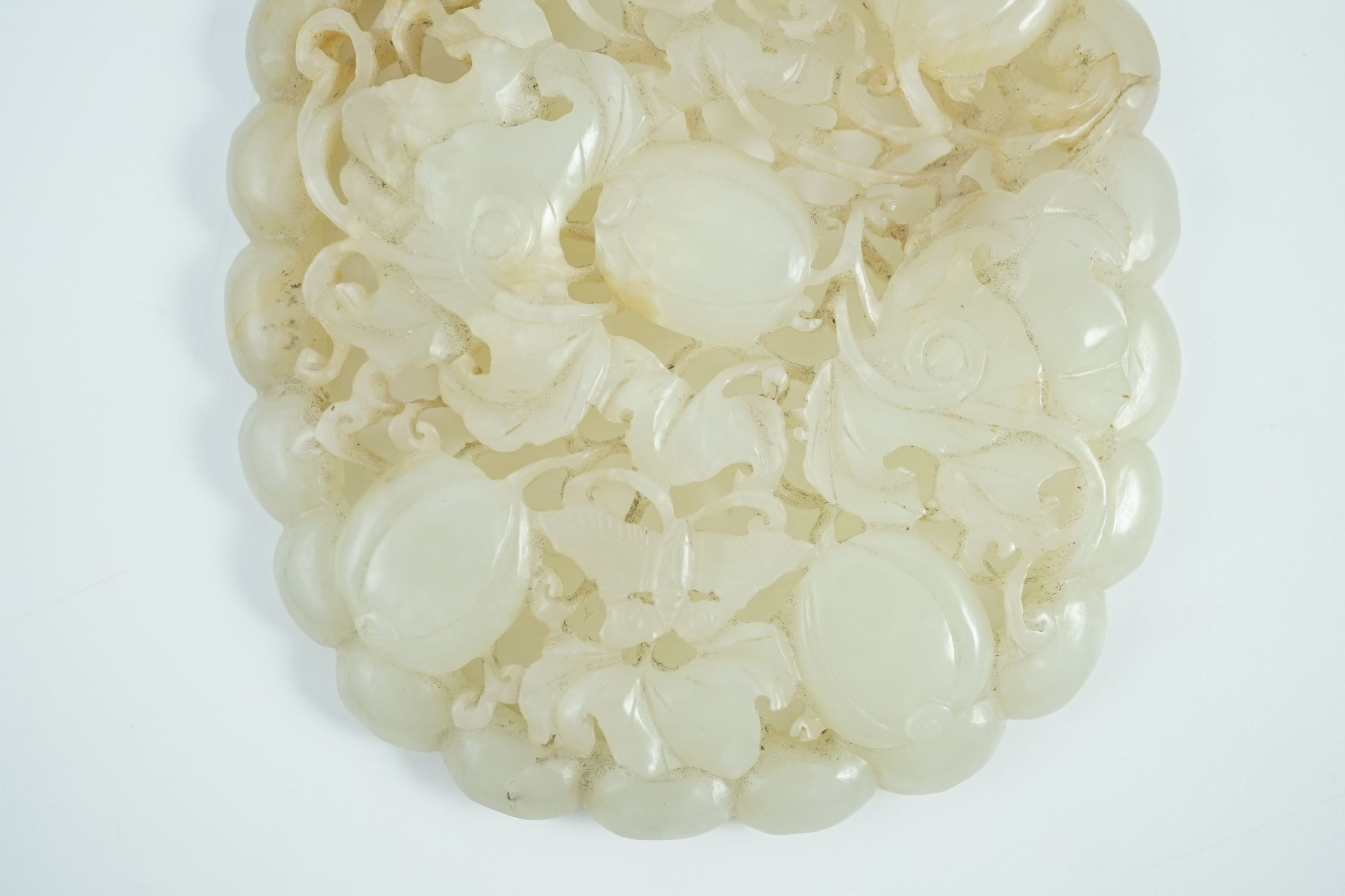 A Chinese pale celadon jade oval openwork plaque, 19th century, 9.8 cm x 8.2 cm